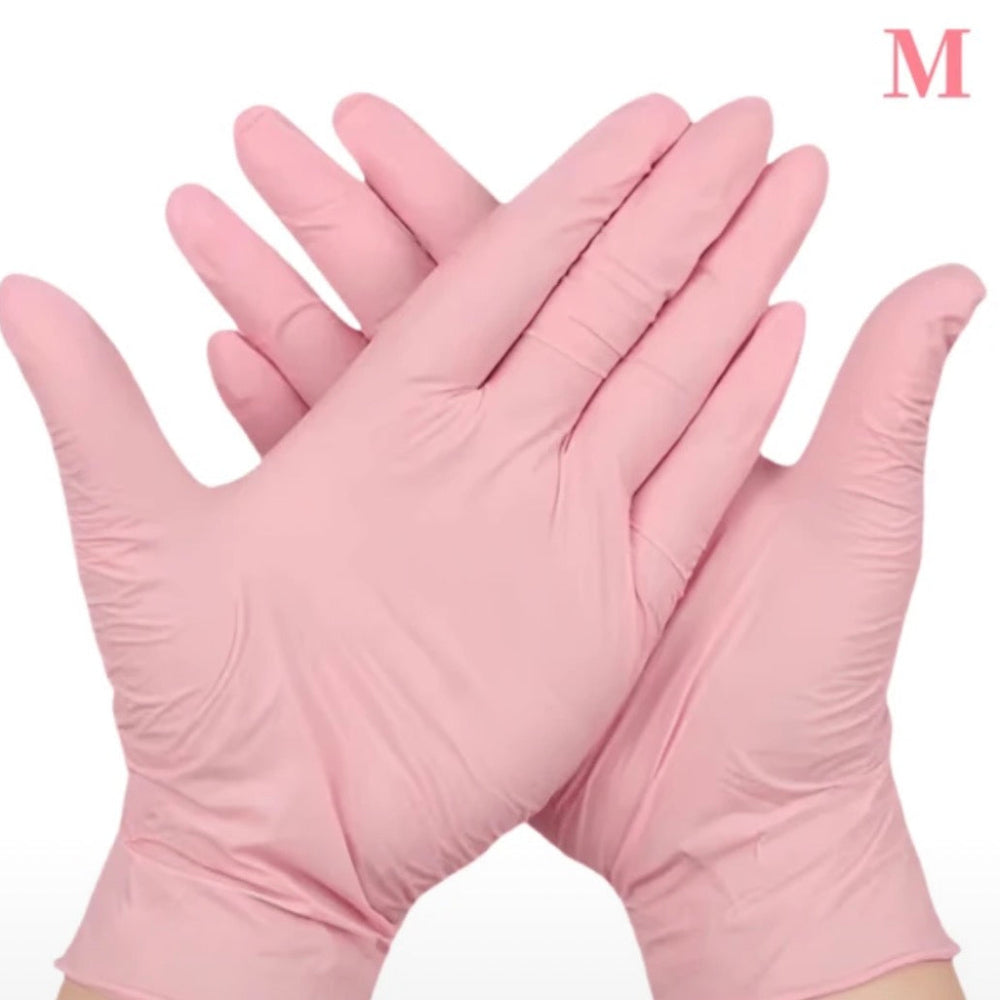 Gants en nitrile roses pour professionnelles de la beauté.